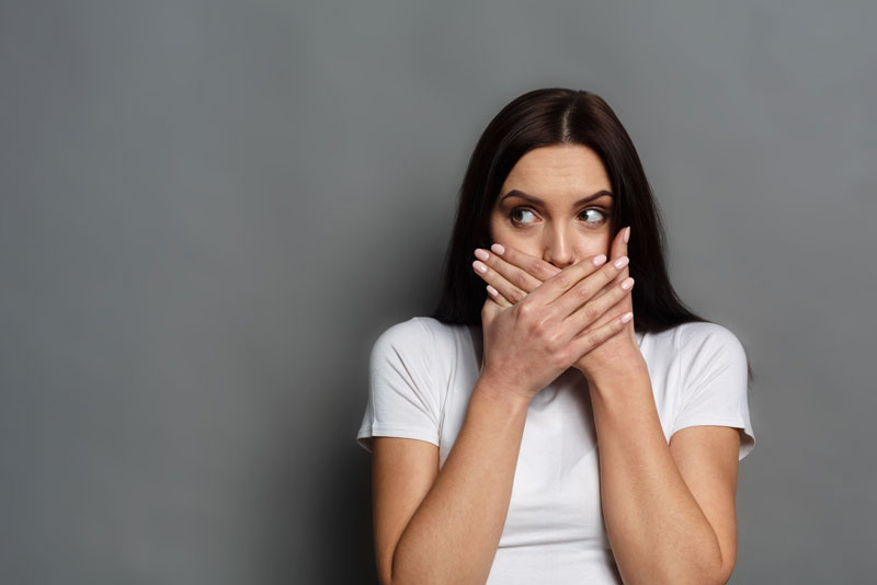 Dental Patient Hiding Her Missing Tooth in Her Smile, Shyly