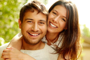 Dental Patients Smiling With Well Cared For Dental Implants In Houston, TX