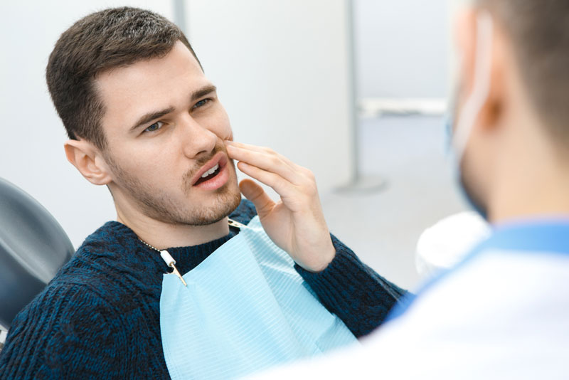 Dental Patient Suffering From Mouth Pain On A Dental Chair, In Houston, TX