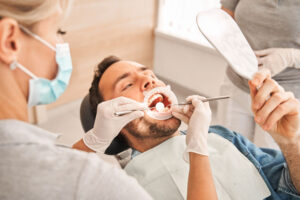 a gum disease patient being checked for periodontal disease by an expert dentist.